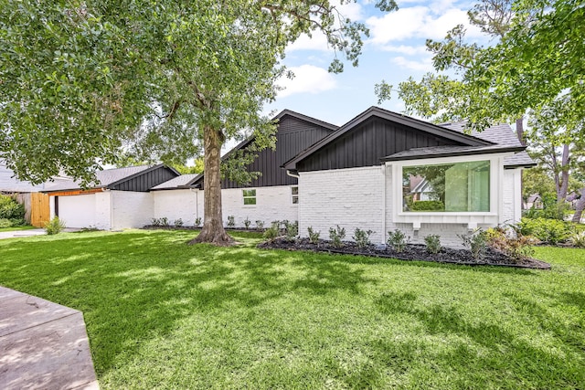 8018 Highmeadow Dr, Houston, TX 77063 - view of front facade with board and batten siding, brick siding, and a front lawn