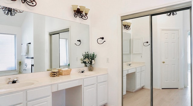 full bath with wood finished floors, a sink, and double vanity