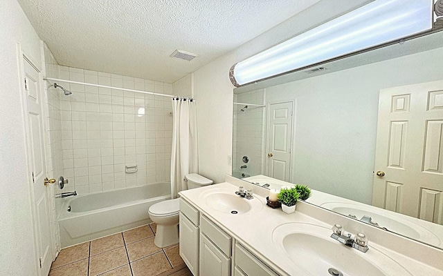 bathroom with visible vents, toilet, shower / tub combo, a sink, and tile patterned floors