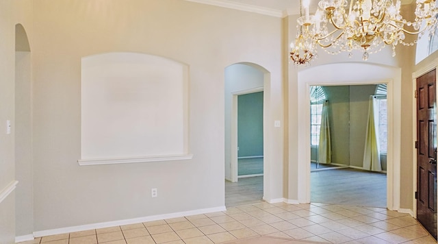 unfurnished room featuring light tile patterned floors, ornamental molding, plenty of natural light, and baseboards