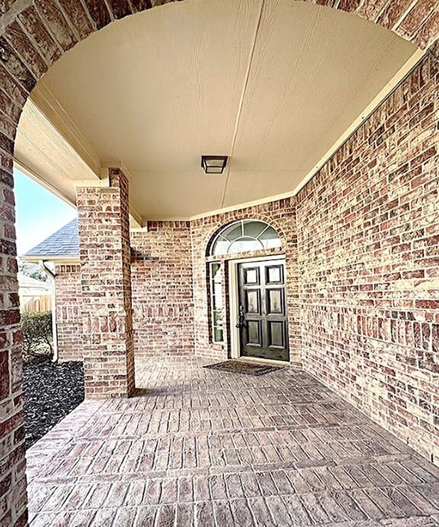 property entrance featuring brick siding