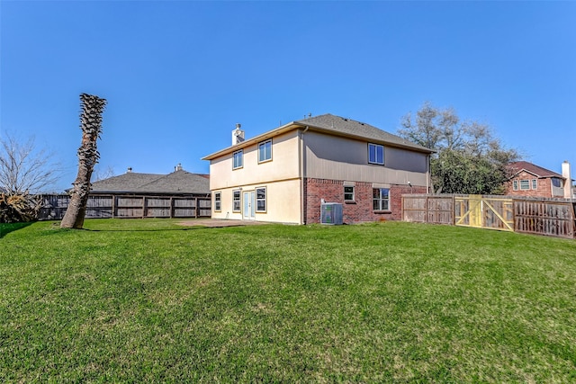 rear view of property with a patio area, a fenced backyard, a lawn, and brick siding