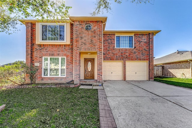 traditional home featuring a garage, a front yard, concrete driveway, and brick siding