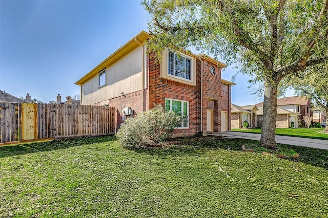 view of front of property with a garage, brick siding, fence, concrete driveway, and a front lawn