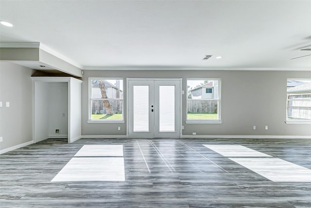 empty room with visible vents, baseboards, french doors, and ornamental molding