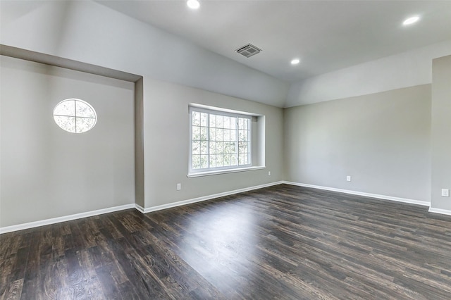 empty room featuring dark wood-style floors, recessed lighting, visible vents, and baseboards