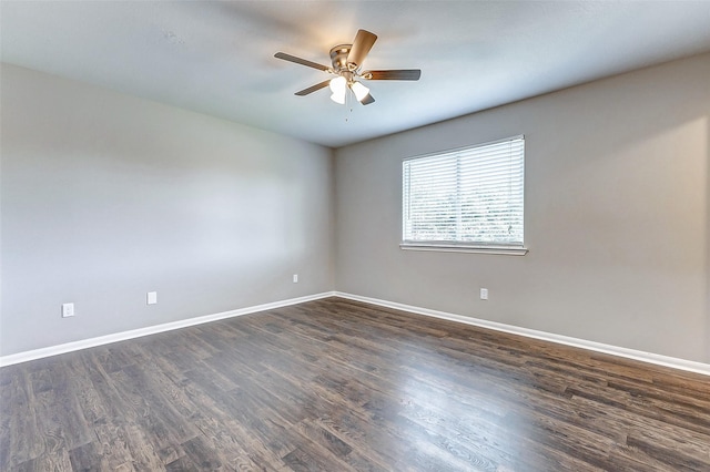 unfurnished room featuring ceiling fan, baseboards, and dark wood-type flooring