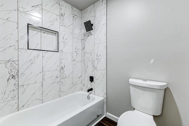 bathroom featuring shower / bath combination, toilet, and baseboards