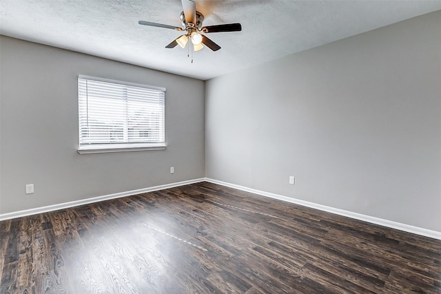 unfurnished room with a textured ceiling, wood finished floors, a ceiling fan, and baseboards