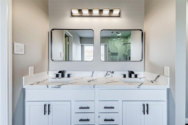 full bath featuring double vanity, a shower stall, and a sink