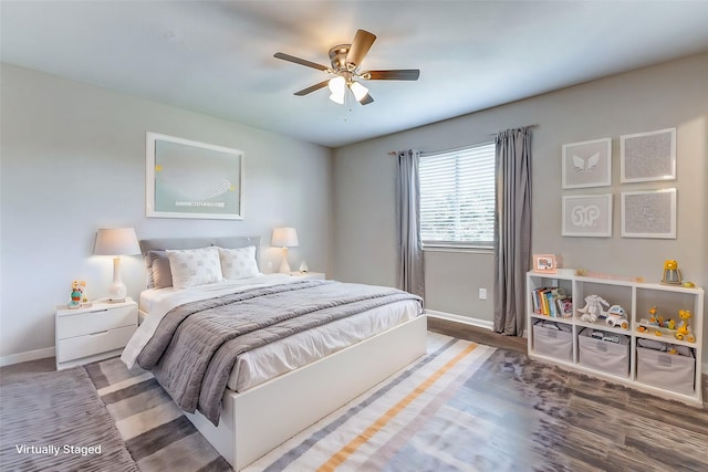 bedroom with ceiling fan, wood finished floors, and baseboards