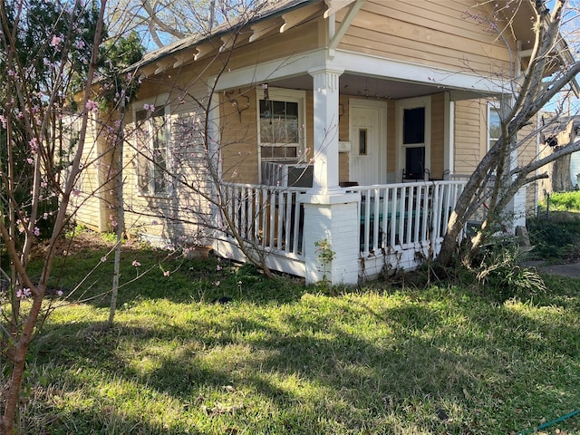 exterior space featuring a porch and a front yard