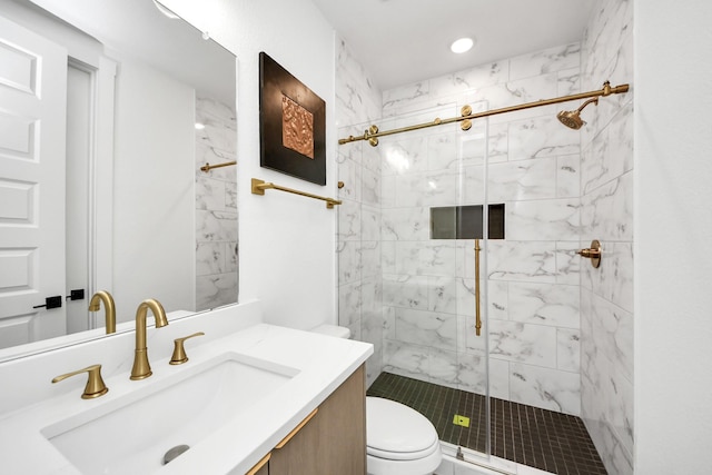 bathroom featuring toilet, a stall shower, and vanity