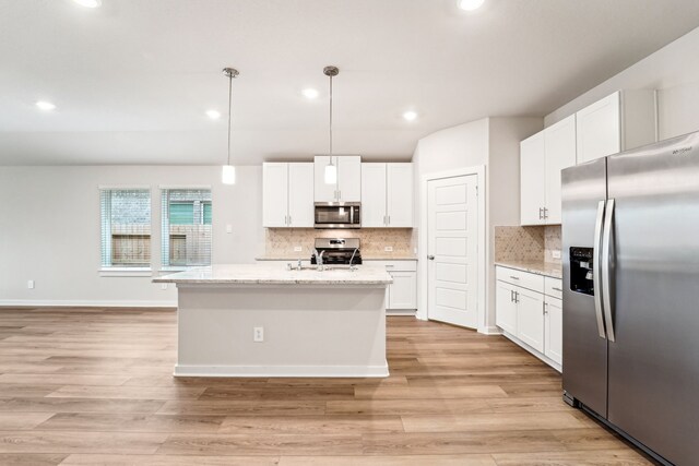 2542 Bay Winds Ln, Baytown, TX 77523 - kitchen featuring stainless steel appliances, white cabinets, tasteful backsplash, light wood-style floors, and recessed lighting