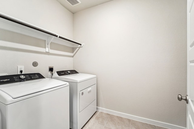 2542 Bay Winds Ln, Baytown, TX 77523 - laundry room featuring independent washer and dryer, baseboards, and light tile patterned floors