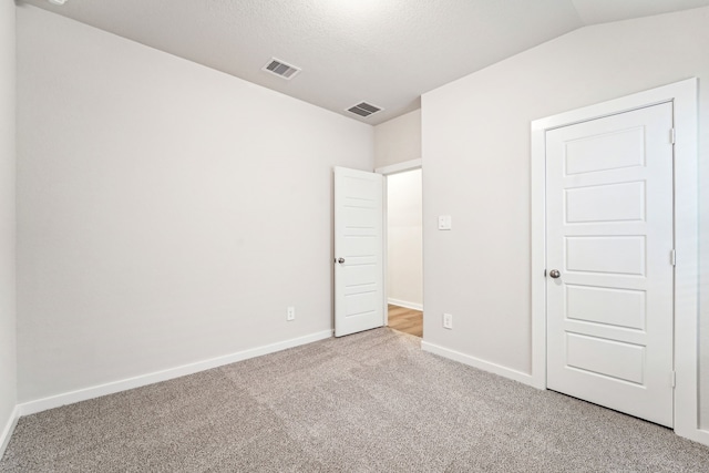 2542 Bay Winds Ln, Baytown, TX 77523 - unfurnished bedroom with carpet flooring, baseboards, and a textured ceiling
