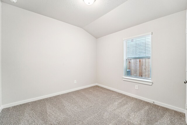 2542 Bay Winds Ln, Baytown, TX 77523 - unfurnished room featuring carpet floors, lofted ceiling, and baseboards