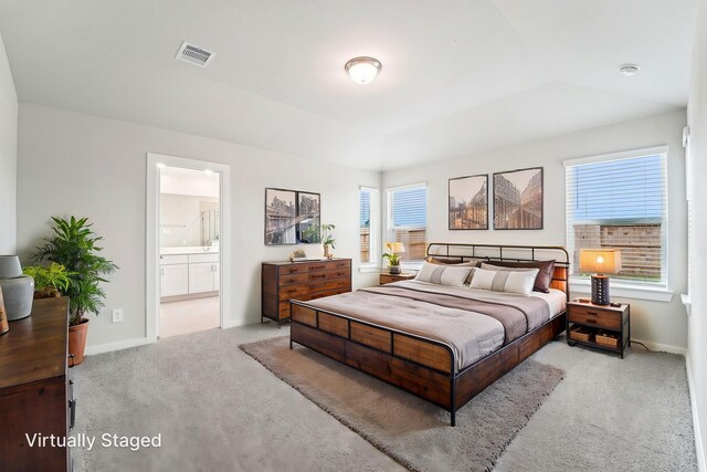 2542 Bay Winds Ln, Baytown, TX 77523 - carpeted bedroom featuring multiple windows, baseboards, and connected bathroom
