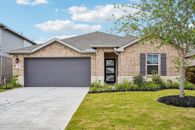 2542 Bay Winds Ln, Baytown, TX 77523 - view of front of property featuring a shingled roof, a front lawn, brick siding, and an attached garage