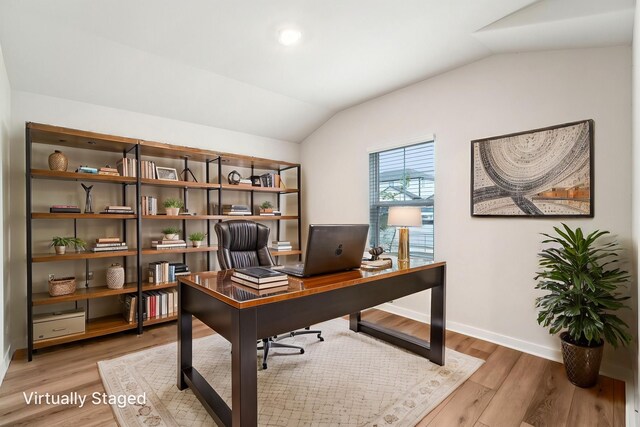 2542 Bay Winds Ln, Baytown, TX 77523 - home office with vaulted ceiling, light wood-type flooring, and baseboards