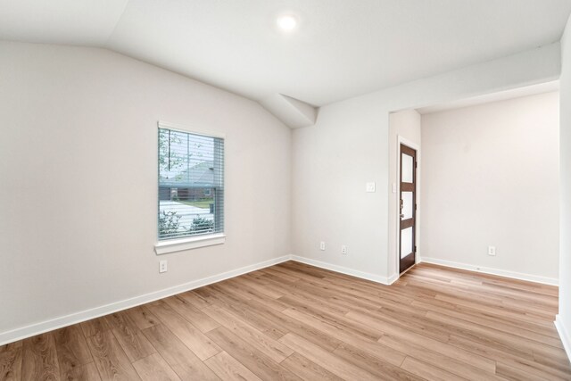 2542 Bay Winds Ln, Baytown, TX 77523 - empty room with light wood-style flooring, lofted ceiling, and baseboards