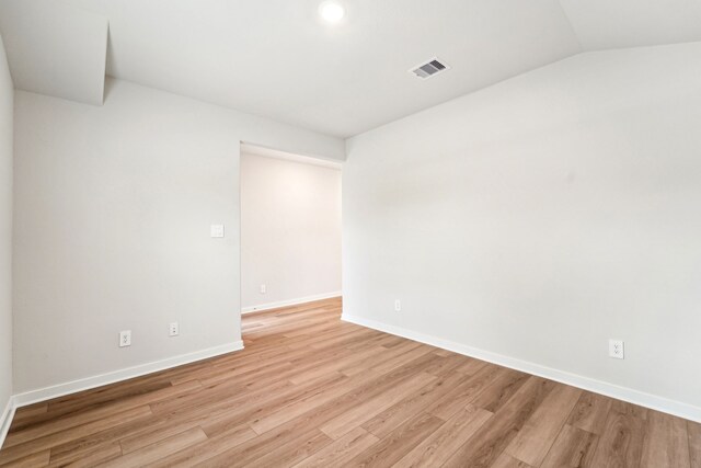 2542 Bay Winds Ln, Baytown, TX 77523 - unfurnished room with light wood-style flooring, baseboards, lofted ceiling, and recessed lighting