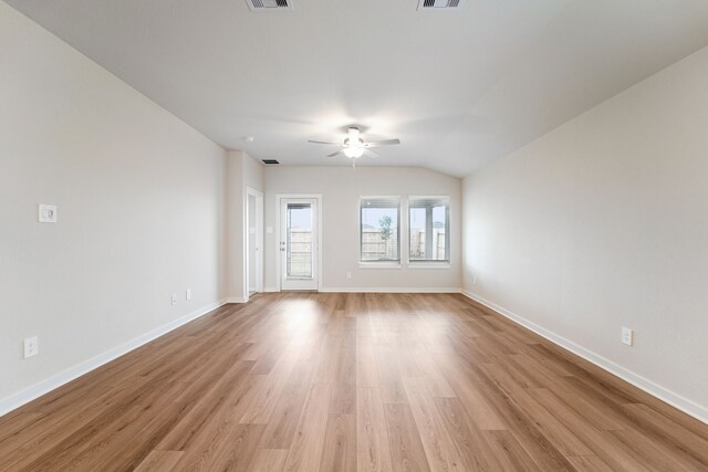 2542 Bay Winds Ln, Baytown, TX 77523 - spare room featuring a ceiling fan, light wood-style flooring, baseboards, and lofted ceiling