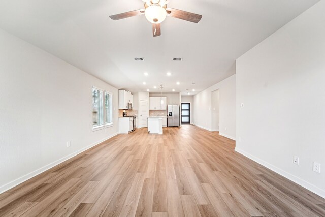 2542 Bay Winds Ln, Baytown, TX 77523 - unfurnished living room with light wood-style floors, a ceiling fan, recessed lighting, and baseboards