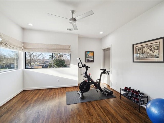 exercise room with a wealth of natural light, visible vents, baseboards, and wood finished floors