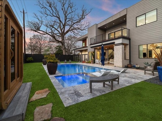 view of pool featuring a patio area, a fenced backyard, a fenced in pool, and a yard