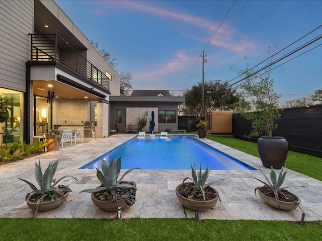 view of swimming pool featuring a patio, fence, and a fenced in pool