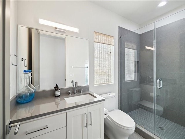 full bathroom featuring a stall shower, vanity, toilet, and recessed lighting