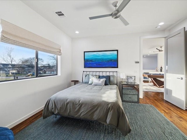 bedroom with baseboards, visible vents, a ceiling fan, wood finished floors, and recessed lighting