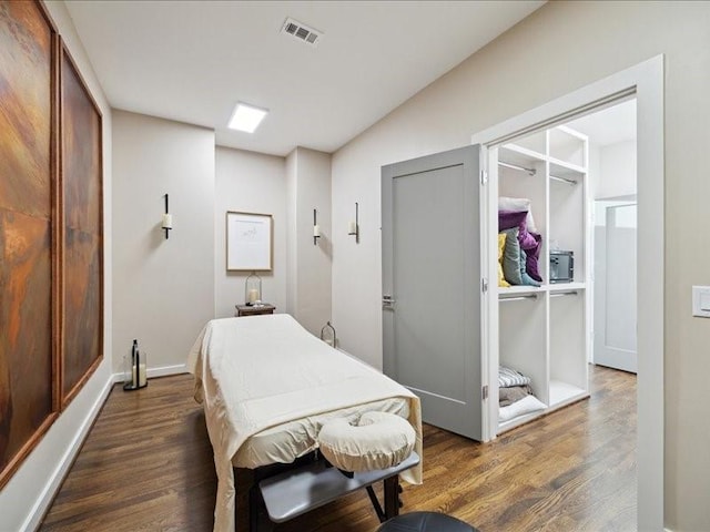 bedroom featuring visible vents, dark wood finished floors, and baseboards