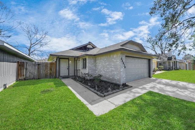 view of front of home with a garage, brick siding, fence, concrete driveway, and a front yard