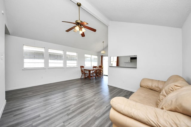 living area with dark wood-style floors, a textured ceiling, beam ceiling, and baseboards