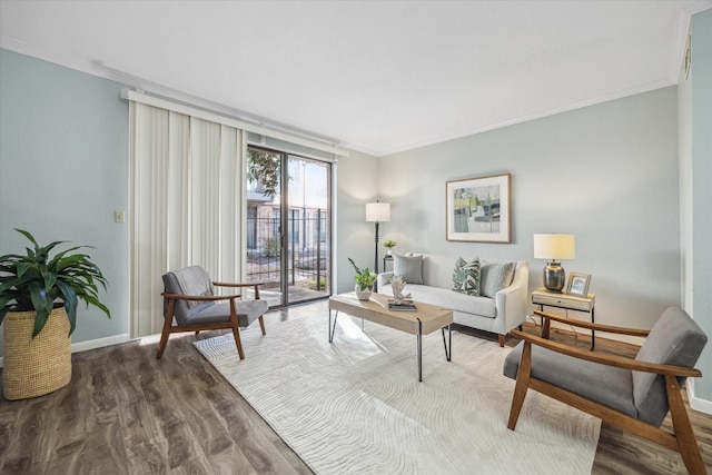 interior space featuring baseboards, wood finished floors, and crown molding