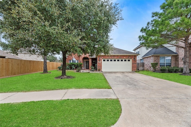 view of front of property with a garage, brick siding, fence, and a front lawn