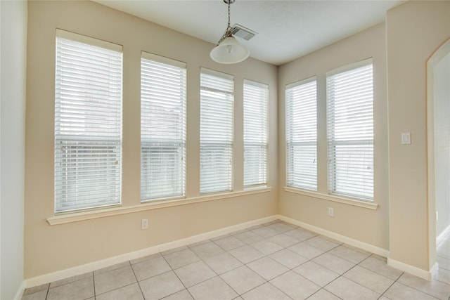 unfurnished dining area featuring light tile patterned floors, visible vents, and baseboards