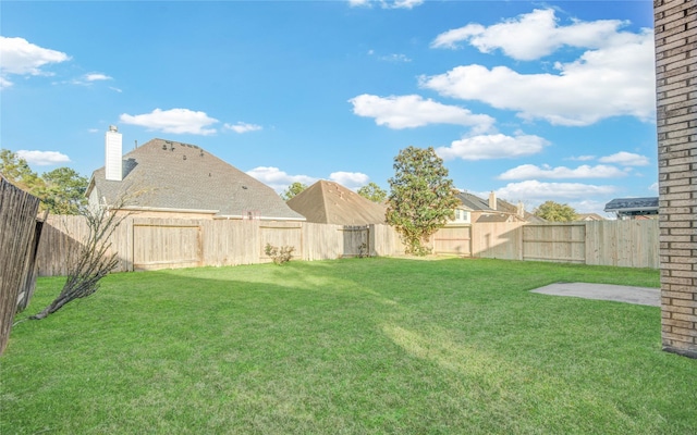 view of yard with a fenced backyard