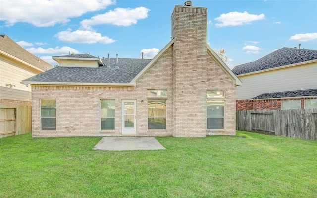 rear view of property with a yard, a shingled roof, and a fenced backyard