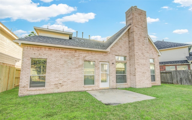 back of house with a patio, a fenced backyard, brick siding, a lawn, and roof with shingles