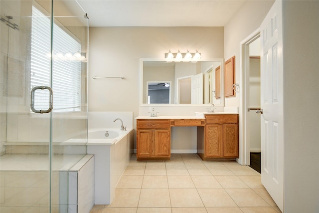 full bathroom with a sink, a shower stall, a bath, and tile patterned floors