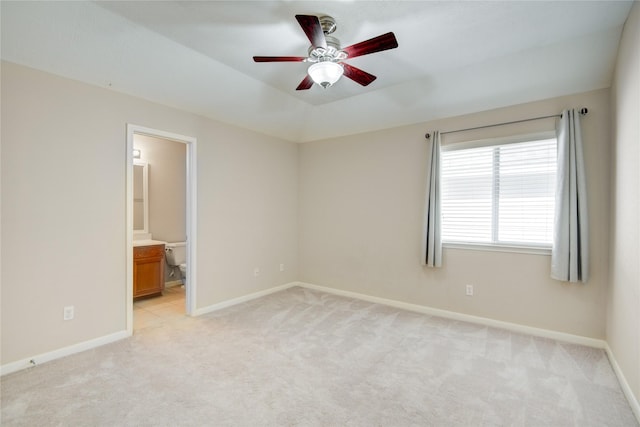 spare room with light carpet, baseboards, a ceiling fan, and lofted ceiling