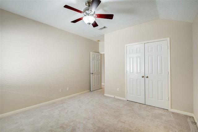 unfurnished bedroom featuring light colored carpet, a closet, visible vents, and baseboards