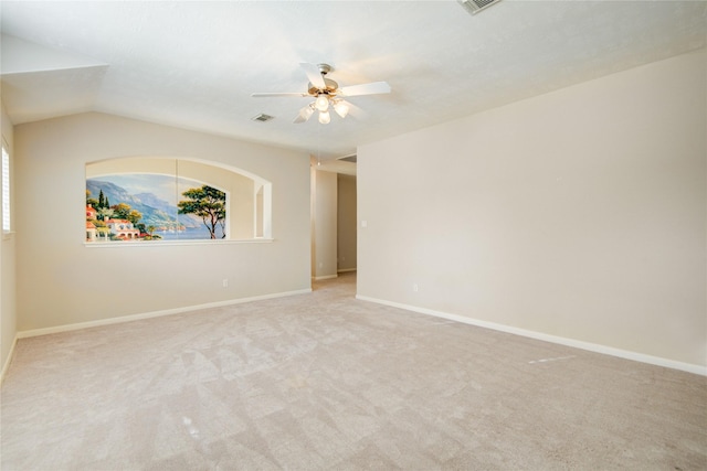 carpeted empty room with a ceiling fan, baseboards, visible vents, and a wealth of natural light