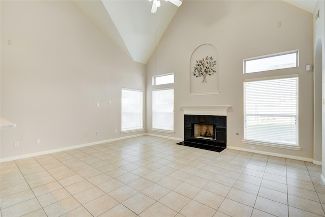 unfurnished living room featuring plenty of natural light, a fireplace, light tile patterned flooring, and baseboards