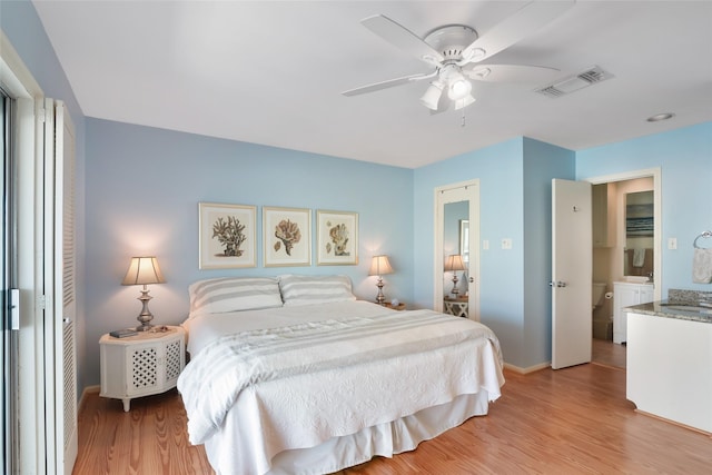 bedroom featuring light wood-type flooring, visible vents, ceiling fan, and baseboards