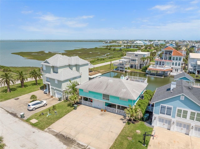 drone / aerial view with a water view and a residential view