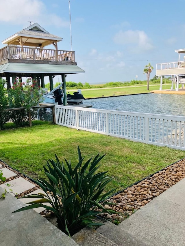 view of community with a water view and a yard